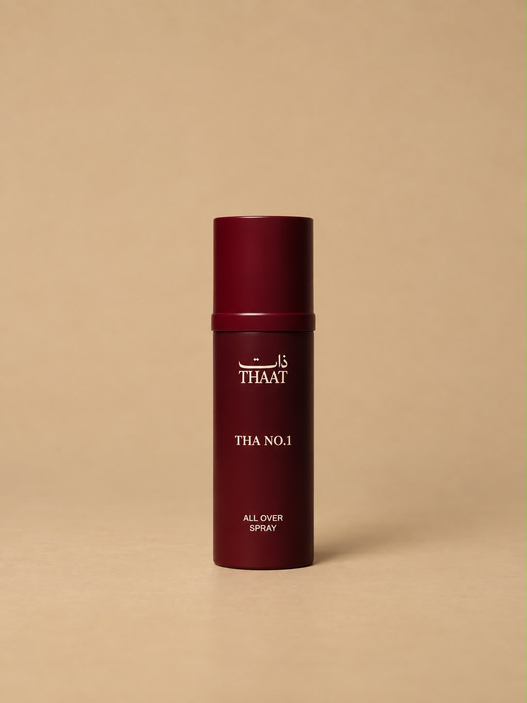 THA NO.1 من ذات — بخاخ All Over Spray بعبوة عنابية — خلفية بيج